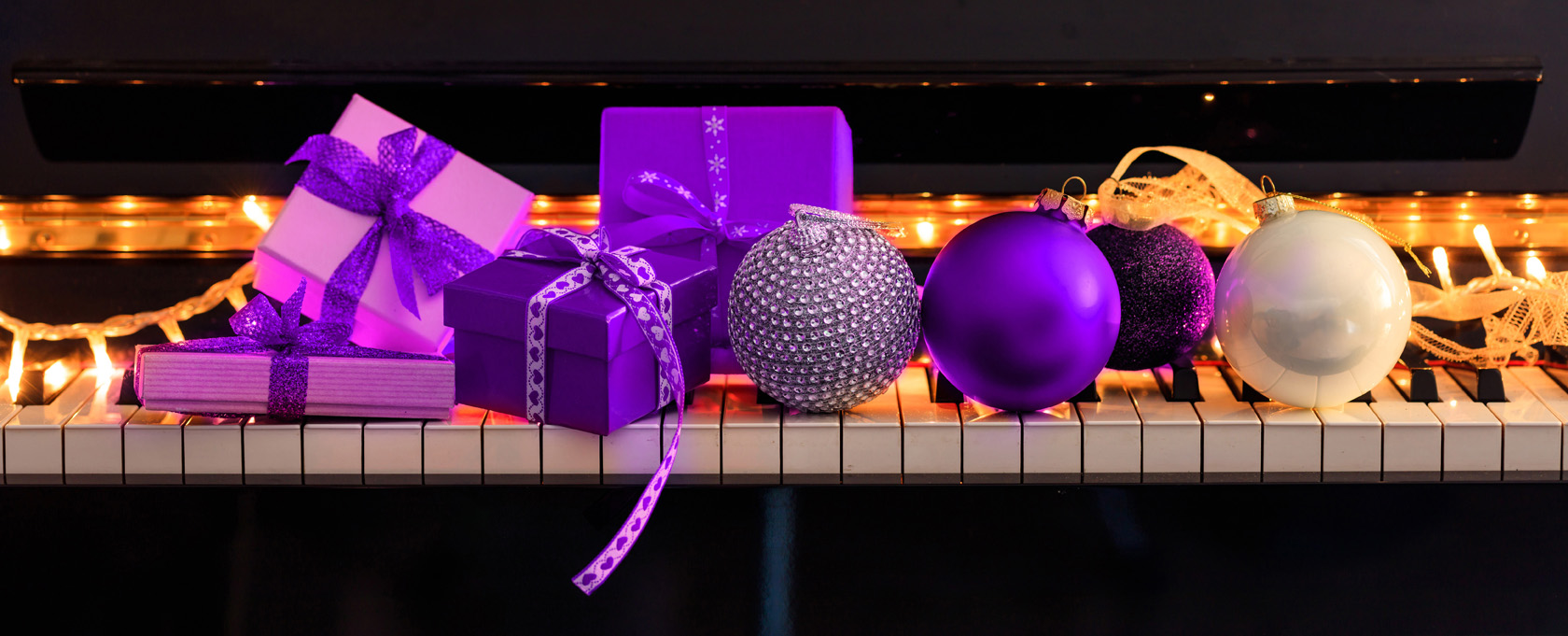 Piano with purple Christmas presents