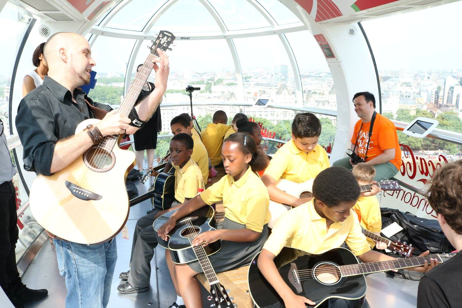 Yamaha Music London holds a guitar lesson on the London Eye with pupils from St George's Cathedral Catholic Primary School