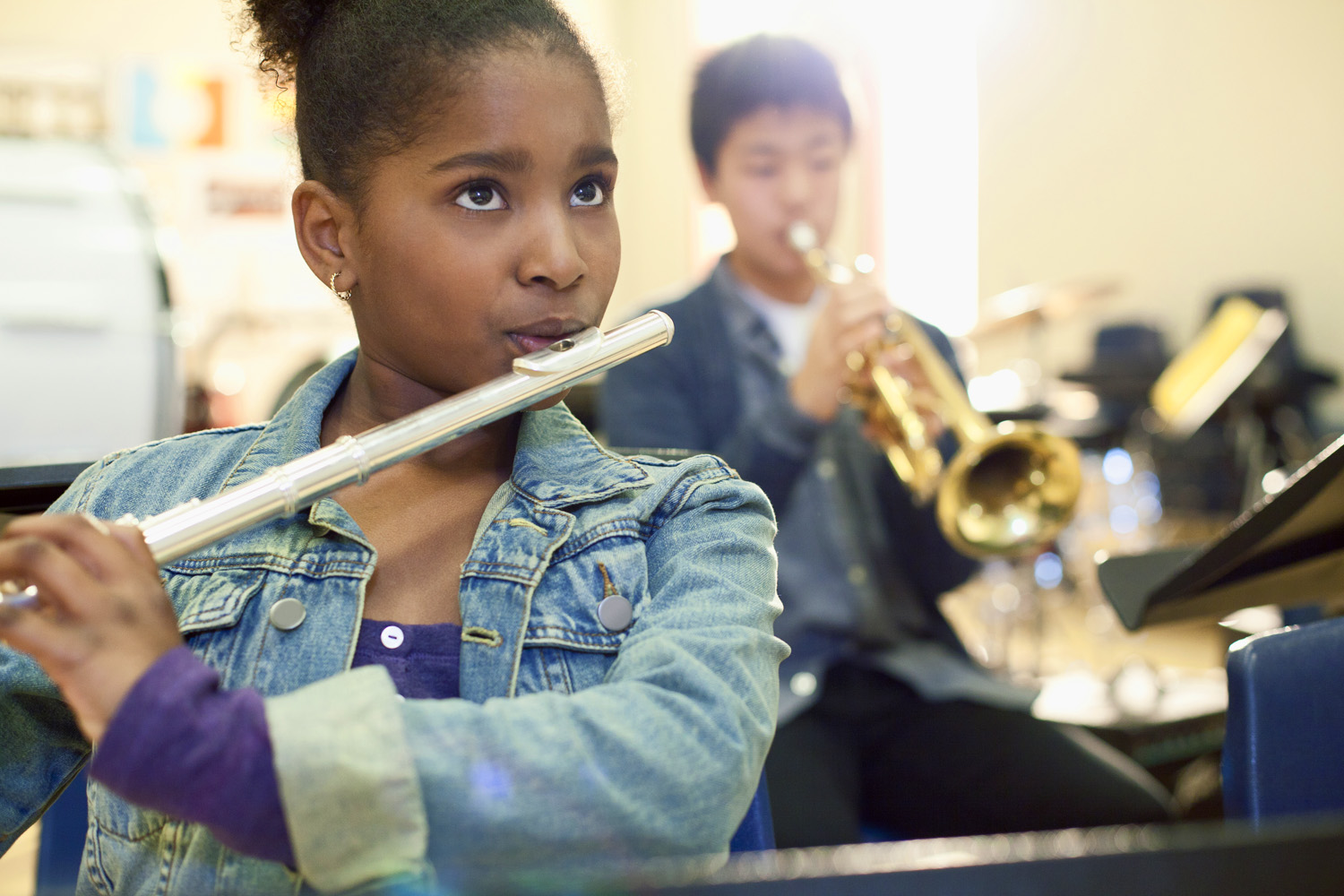 Photo of a teenager playing flute in a school band
