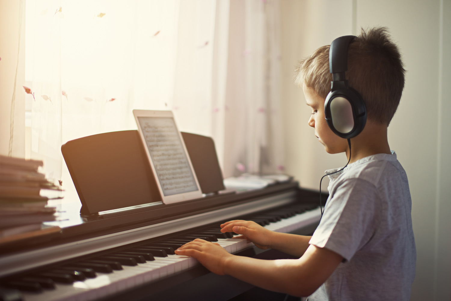 Photo of a child practising piano at home