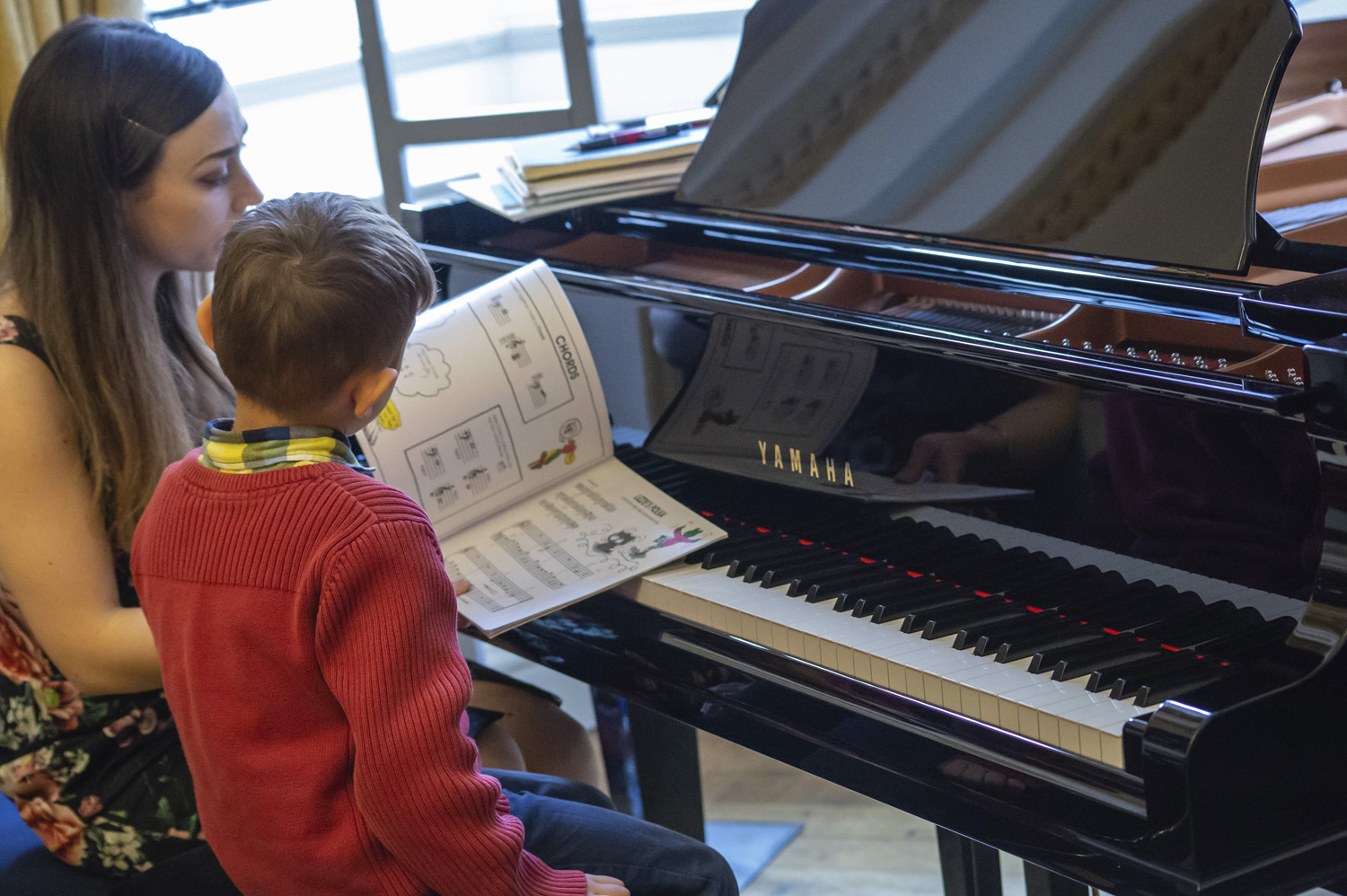 Photo of a piano teacher giving a lesson in the Yamaha Piano Hall