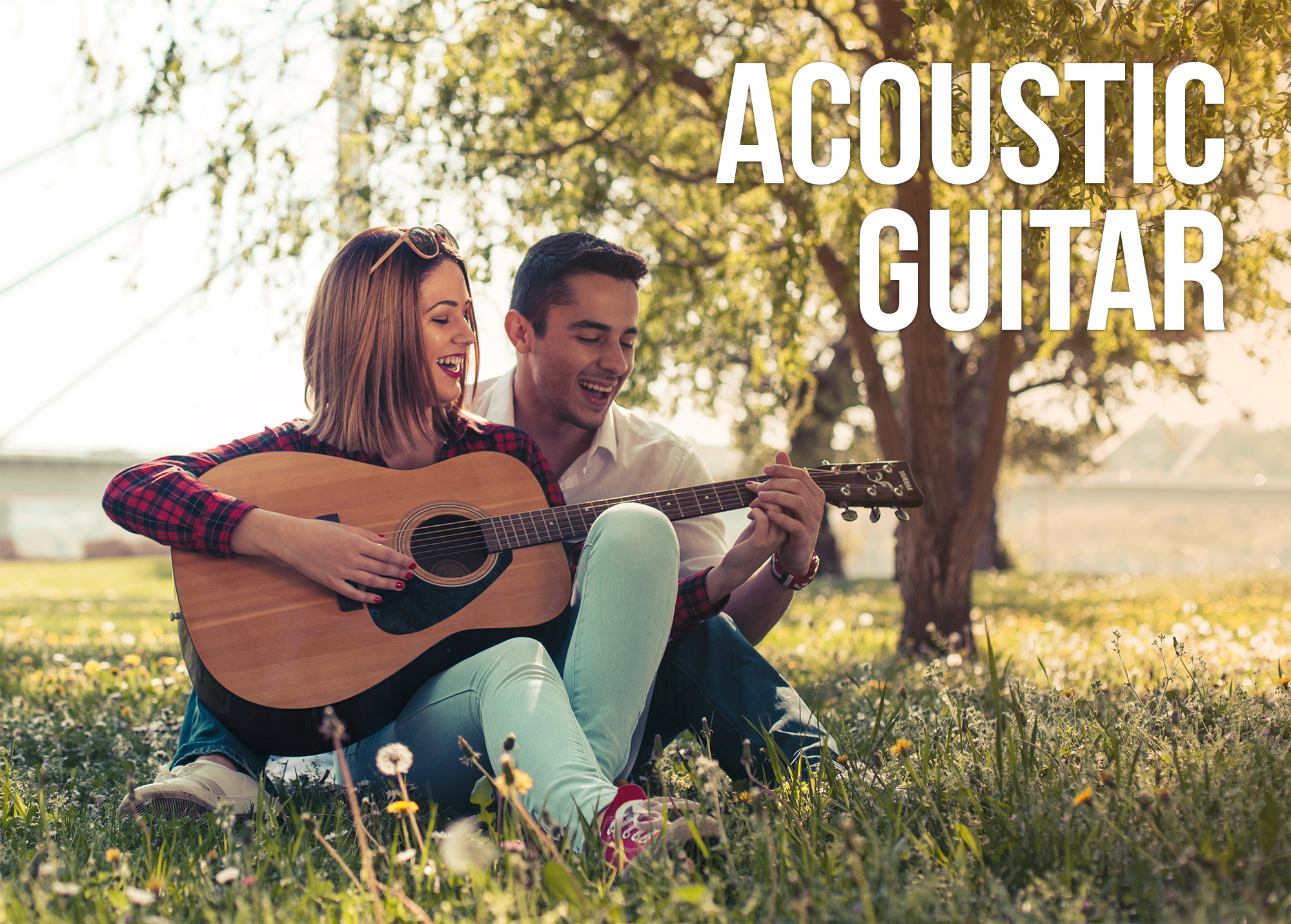 A couple playing a Yamaha acoustic guitar in a park