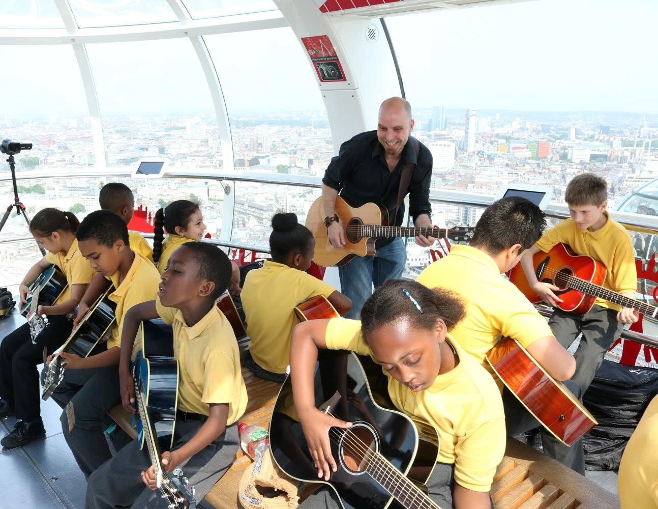 Yamaha Music London holds a guitar lesson on the London Eye with pupils from St George's Cathedral Catholic Primary School